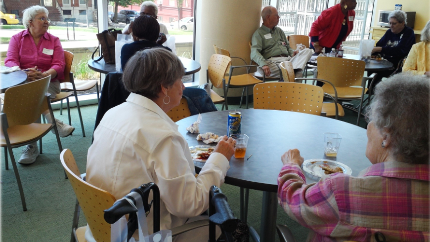 Three tables of attendees. 