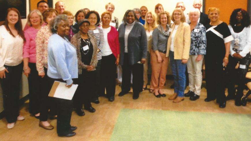 A group of alumni pose for a photo. 