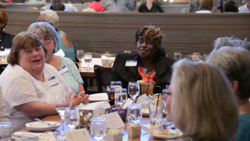 A group of attendees sit at a table. 