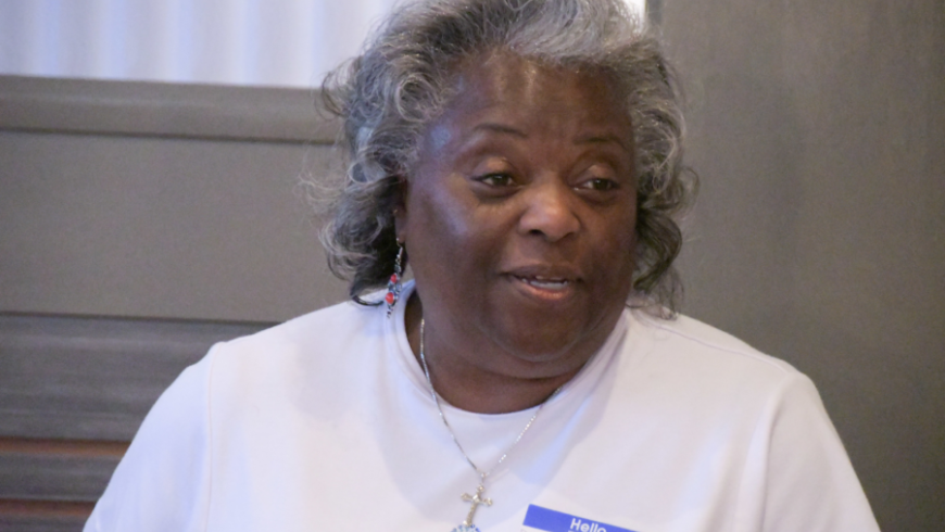 Closeup image of a woman in a white shirt. 