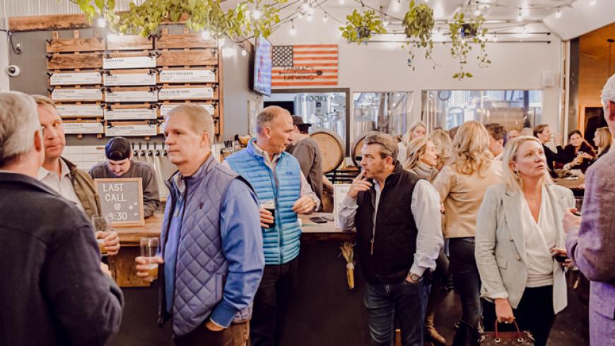 A photo of the crowd inside the taproom at Farmacy Brewing, the venue for Barrels & Bonfires.