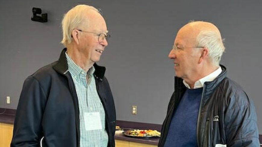 Two men have a conversation.