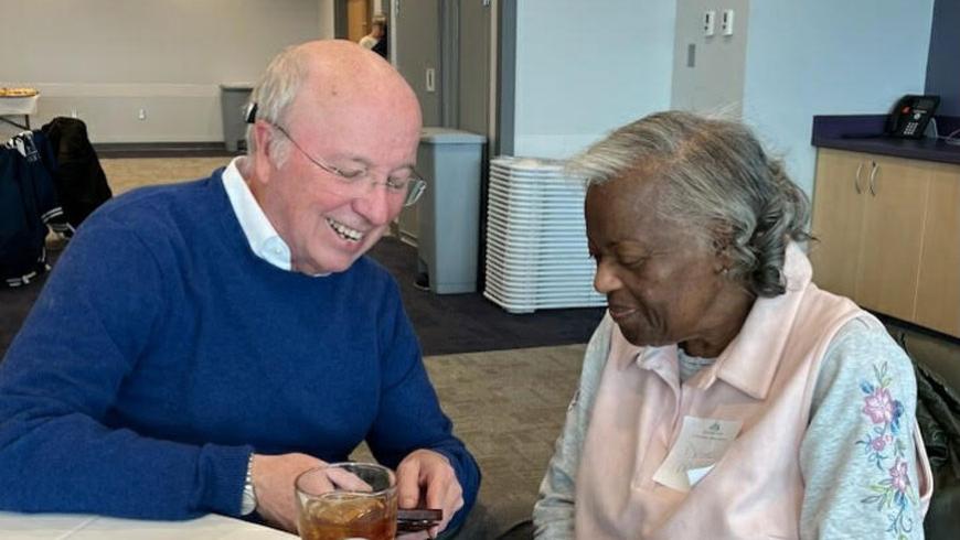 A man and a woman sit next to each other and have a conversation.
