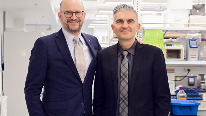 Drs. Brad Schlaggar and Ali Fatemi stand for a photo inside the Johnston Lab.