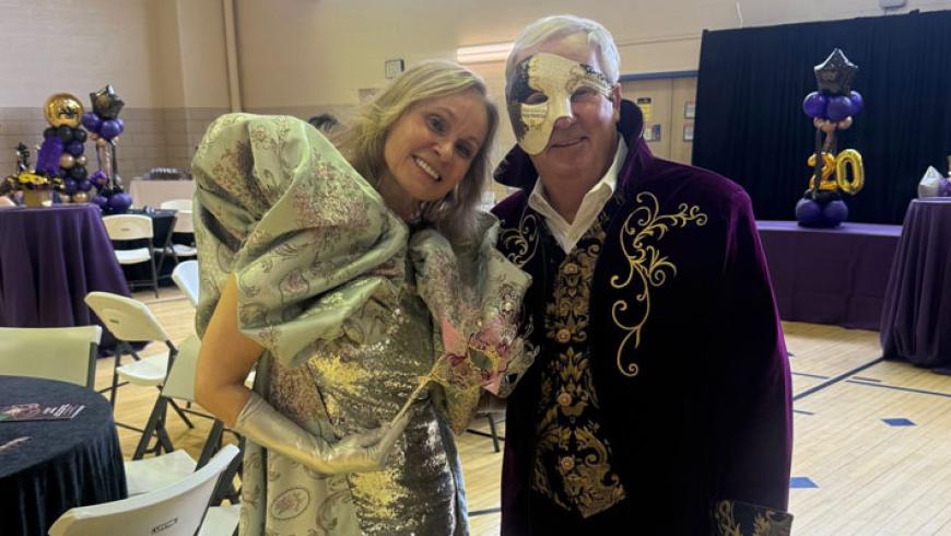 Dr. Cristina Sadowsky and Tom Novotny, Kennedy Krieger's Vice President of Philanthropy, at the 20th anniversary gala. Both are dressed in masquerade ball-themed attire.