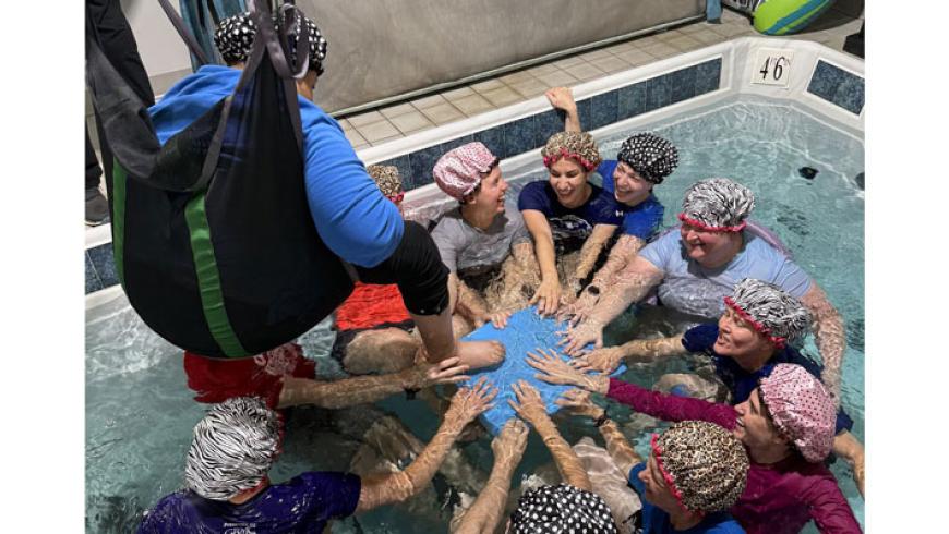 ICSCI teams members in the pool at the aquatic therapy center.