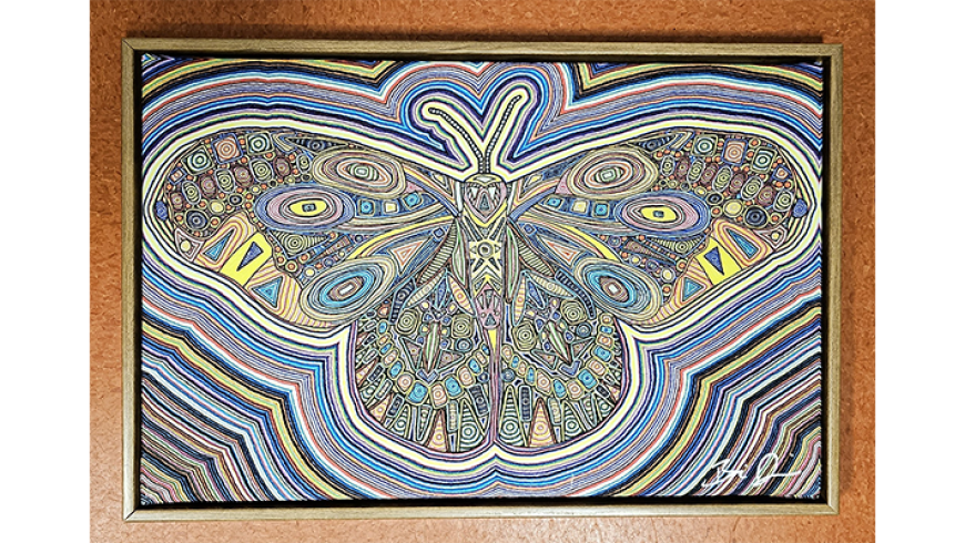 A framed artwork of a stylized butterfly composed of intricate, colorful geometric patterns with radiating multicolored lines surrounding it.