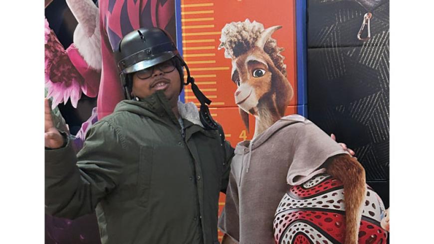 A CORE Foundations participant stands next to a cardboard cutout of a movie character.