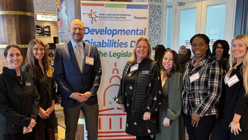 Kennedy Krieger and MCDD staff members in front of a Developmental Disabilities Day at the Legislature banner.