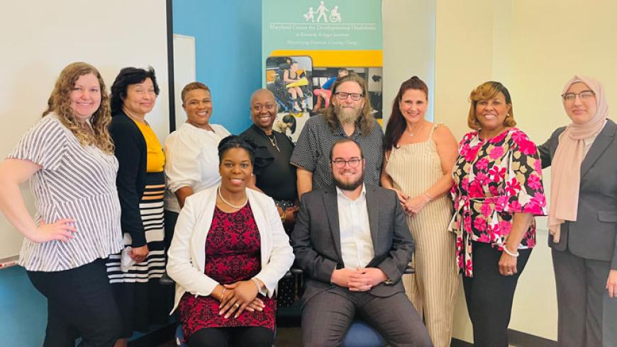 10 attendees smile in a group photo at the 2025 collaborative conference.