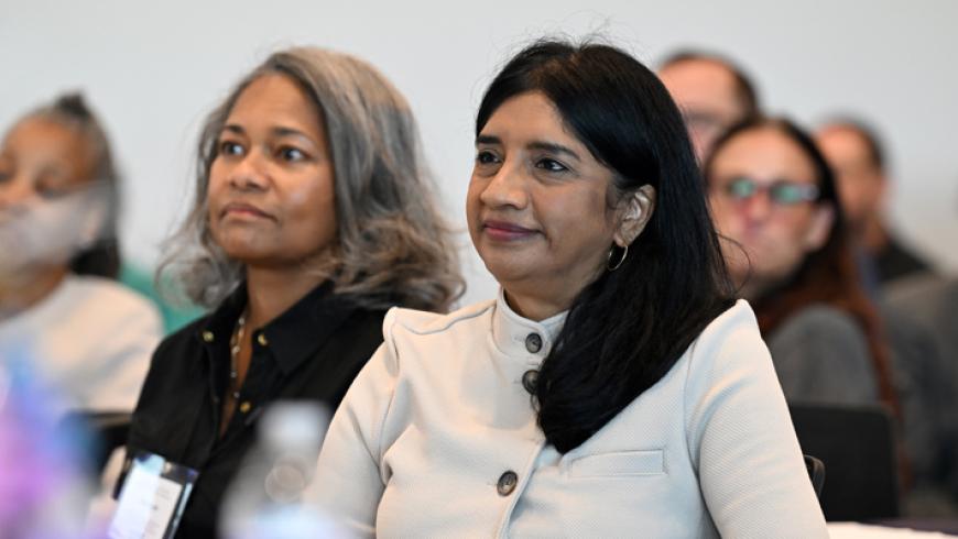 Maryland Lt. Governor Aruna Miller sits among other conference attendees and listens to a speech.