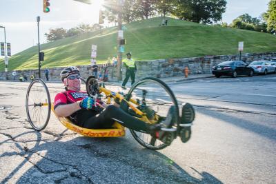 A hand cyclist outside.