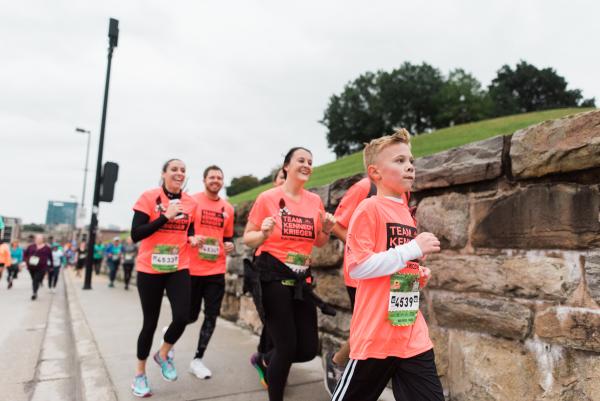 A group of adults and kids running together.