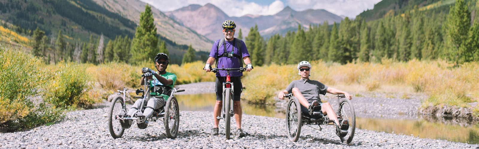 Three men on bikes.